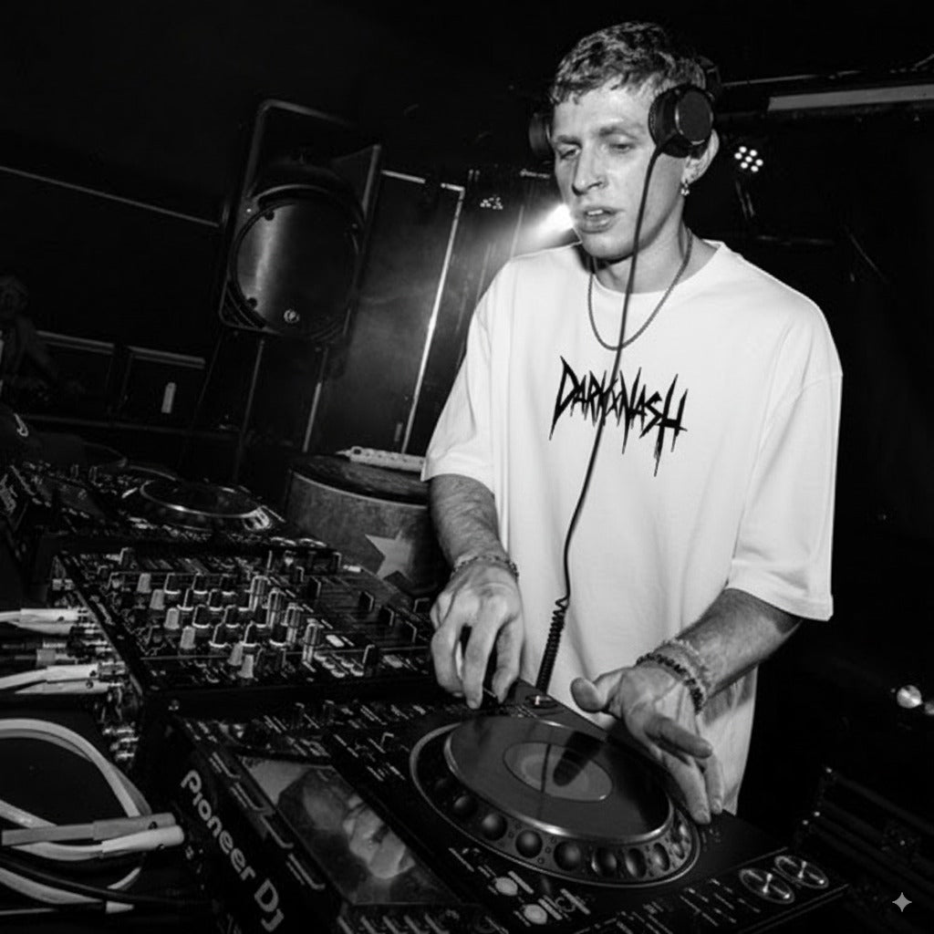 DJ am Mischpult im Club trägt weißes DARKXNASH Techno T-Shirt, Core Edition